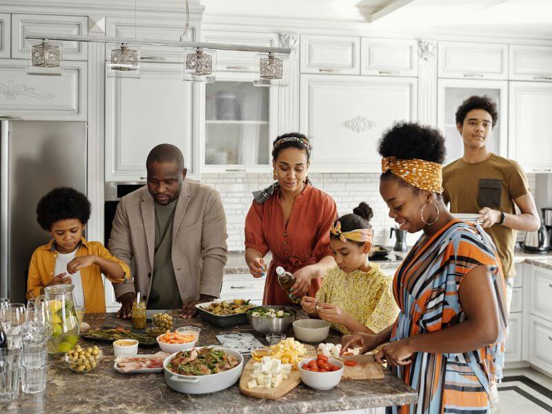 Family cooking a meal together in a kitchen
