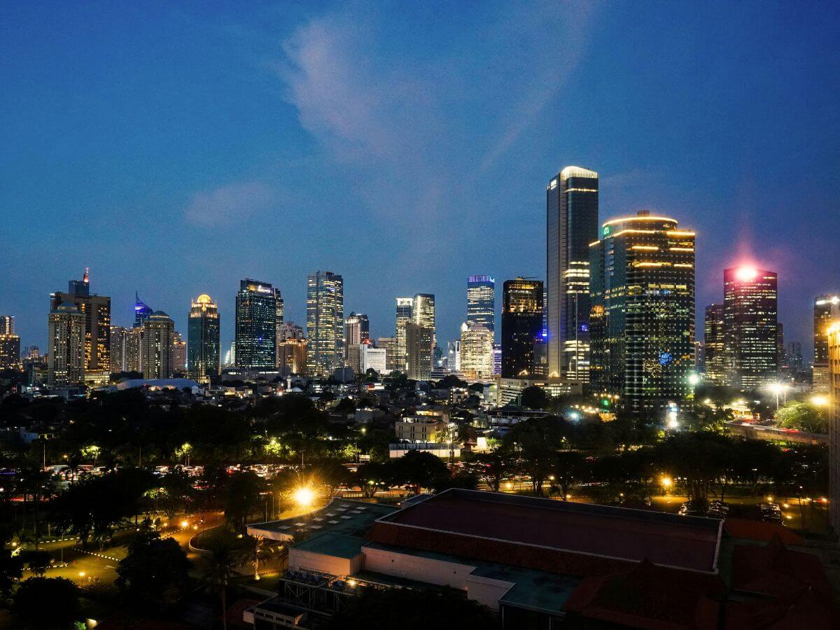City skyline at dusk with lit office towers